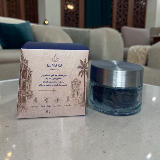 LumaHouse ELMARA PERFUMES Al Dar scented oud wood in a 55g glass jar with a decorative box on a marble table.