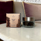 LumaHouse Elmara Perfumes Al Dar scented oud in a 55g glass jar with its decorative box on a marble table.
