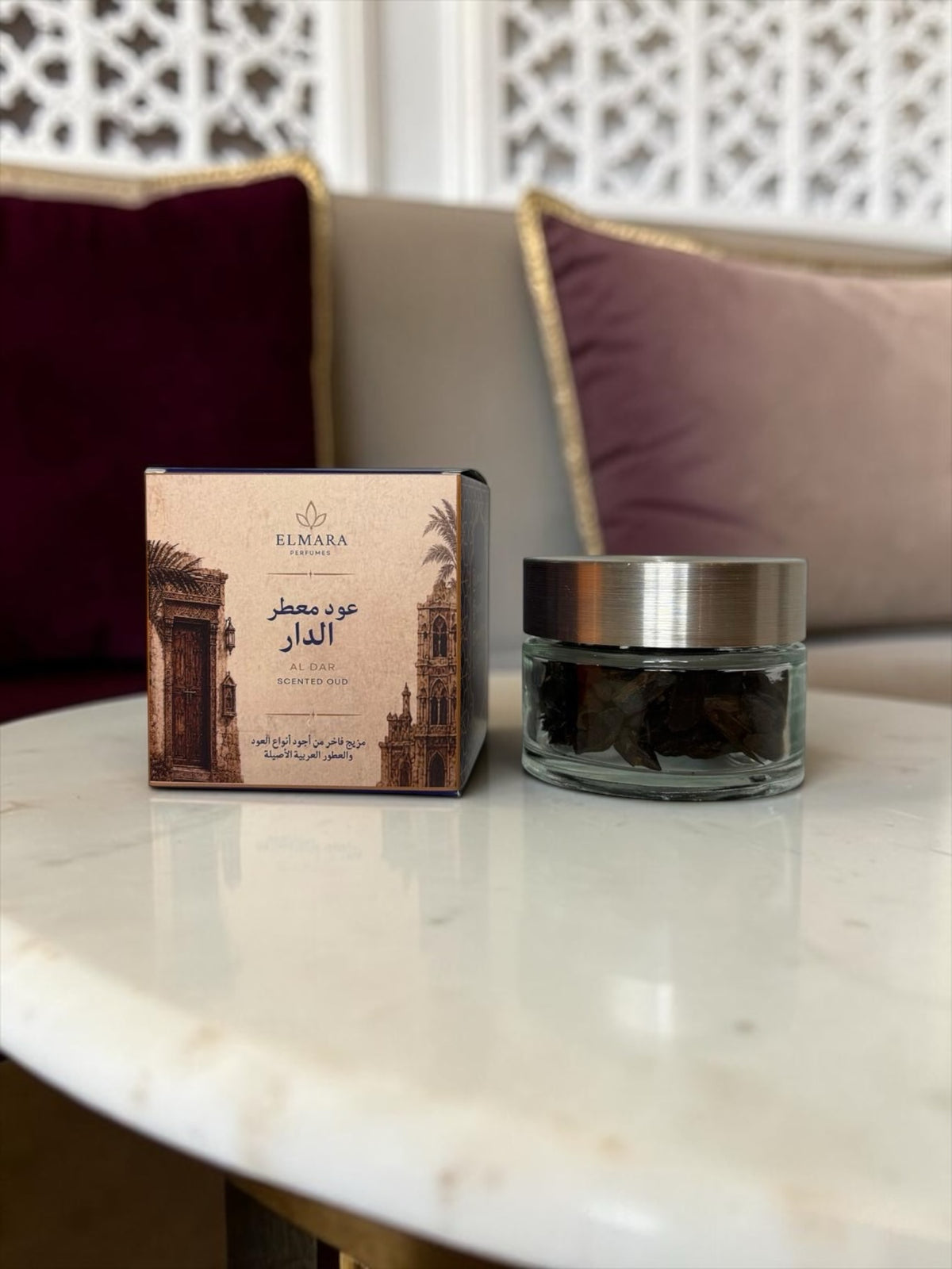 LumaHouse Elmara Perfumes Al Dar scented oud in a 55g glass jar with its decorative box on a marble table.